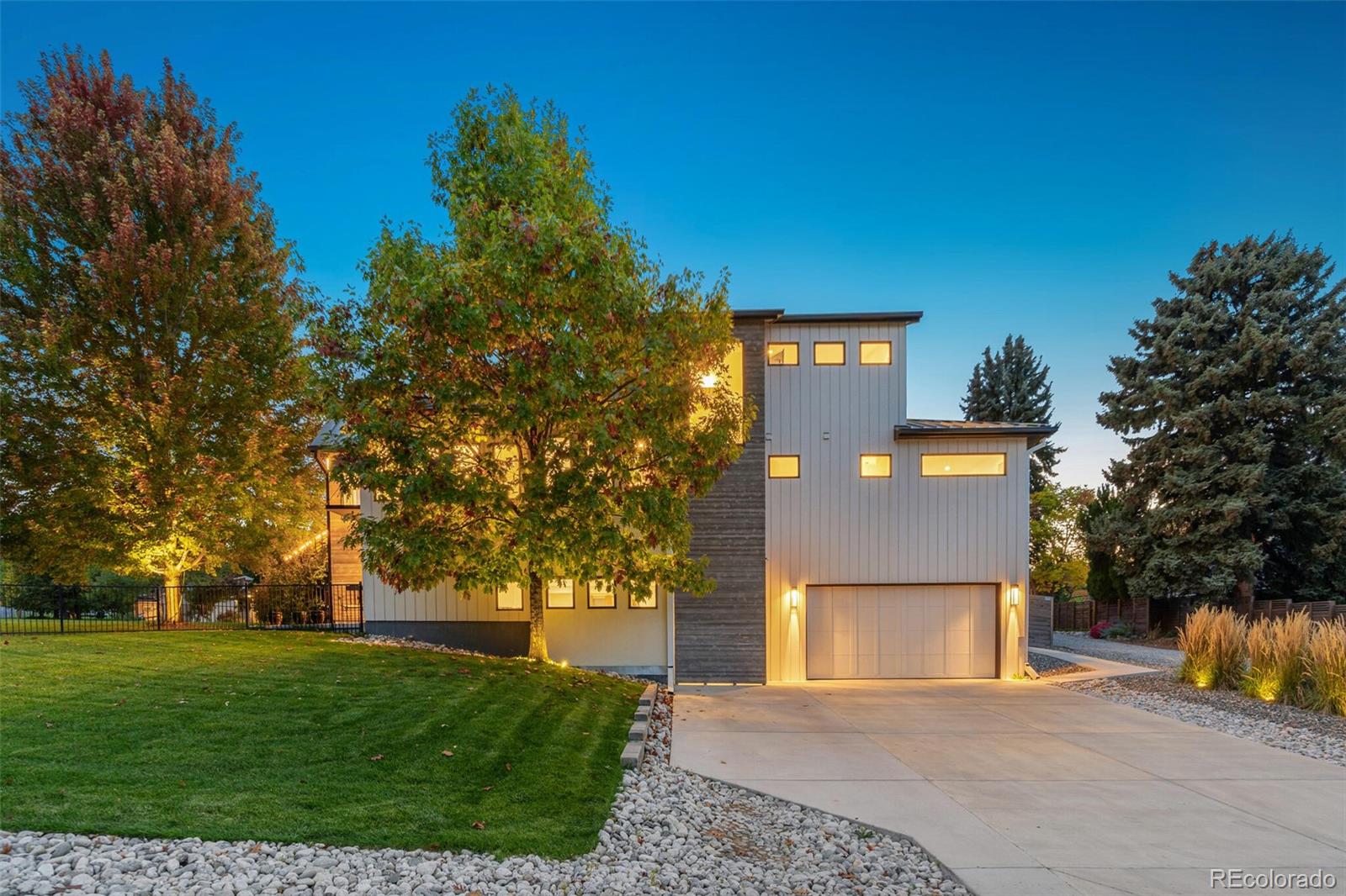 4077 Everett Street Wheat Ridge, CO 80033 - Photo 4 of 50 a front view of a house with a yard and trees