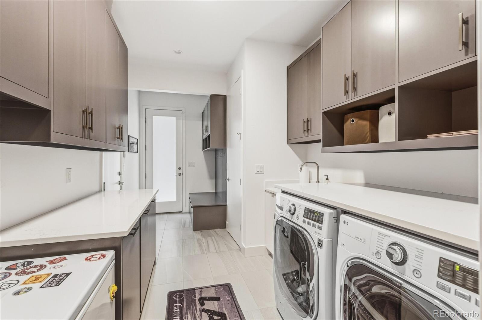 4077 Everett Street Wheat Ridge, CO 80033 - Photo 42 of 50 a utility room with sink dryer and washer