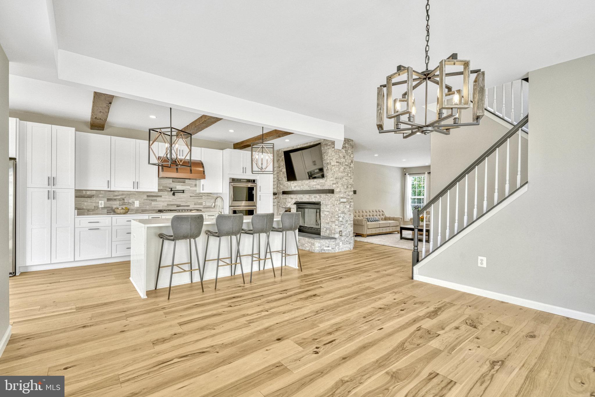 42751 Bennett Street Chantilly, VA 20152 - Photo 12 of 61 a view of a living room and kitchen with granite countertop wooden floor
