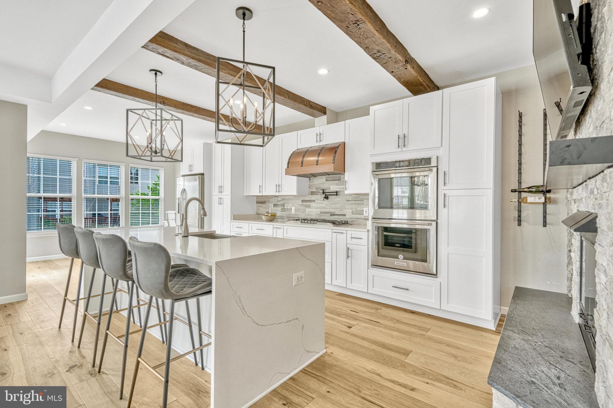 42751 Bennett Street Chantilly, VA 20152 - Photo 14 of 61 a kitchen with stainless steel appliances granite countertop a stove and white cabinets