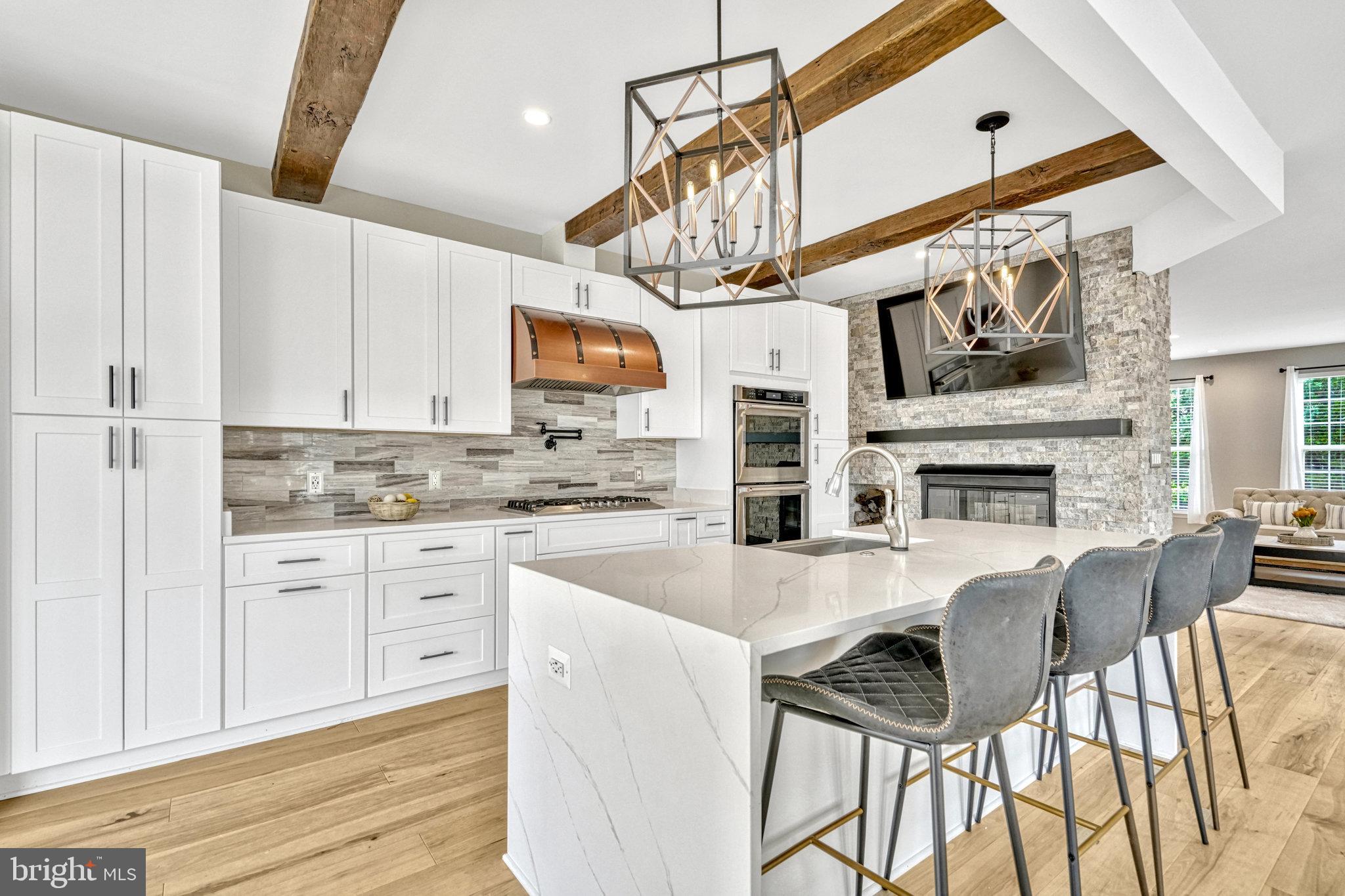 42751 Bennett Street Chantilly, VA 20152 - Photo 16 of 61 a kitchen with a table chairs cabinets and wooden floor