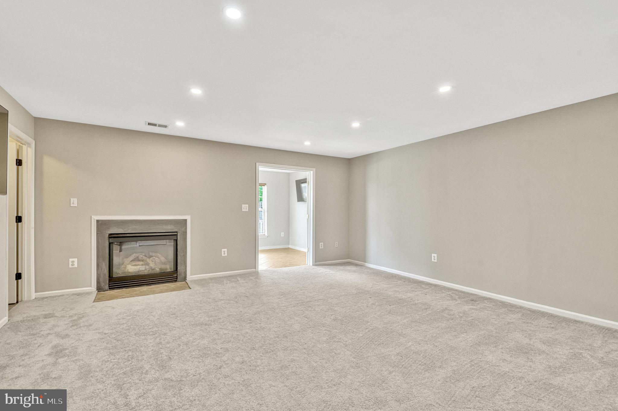 42751 Bennett Street Chantilly, VA 20152 - Photo 41 of 61 a view of an empty room with a fireplace and a window