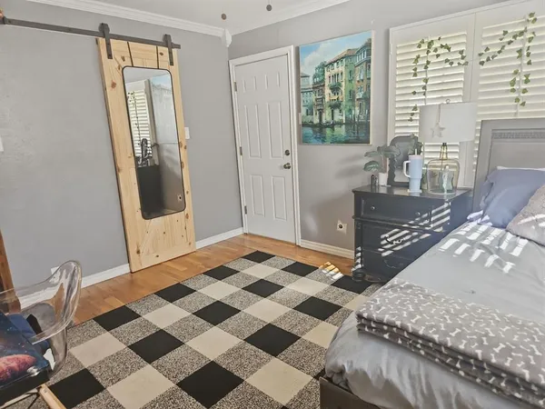 a living room with a black white checkered floor with couches chair and a coffee table