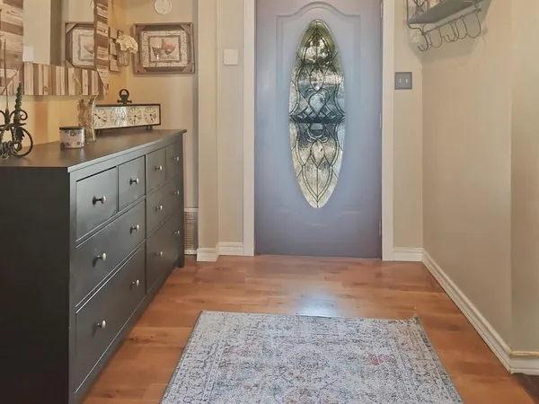 a view of a bedroom with a bed and a mirror