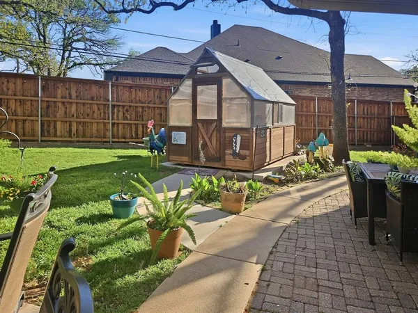 a view of a chairs and table in backyard