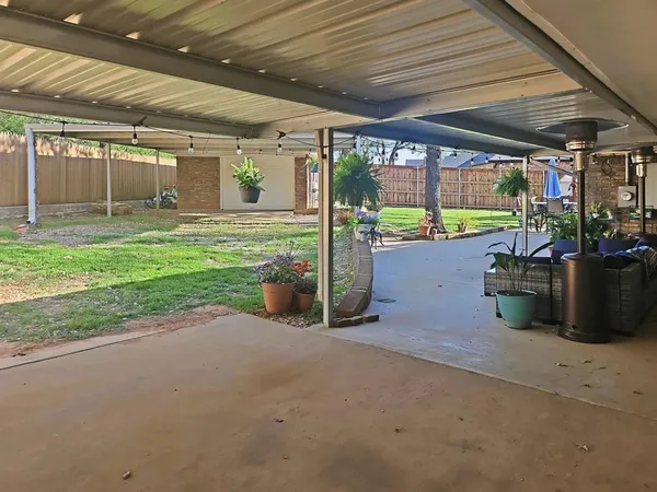a view of a house with backyard porch and sitting area