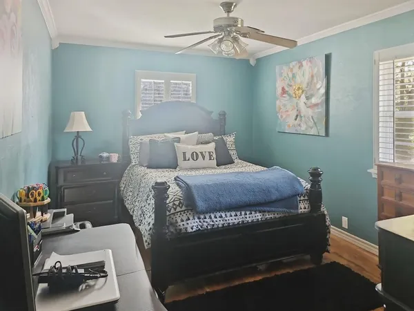 a bedroom with a bed and a window