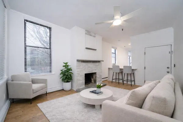 a living room with furniture and a fireplace