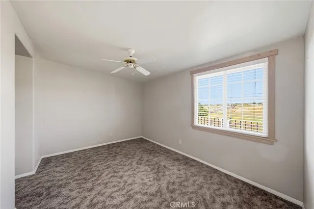 a kitchen with granite countertop white cabinets stainless steel appliances a sink and a window