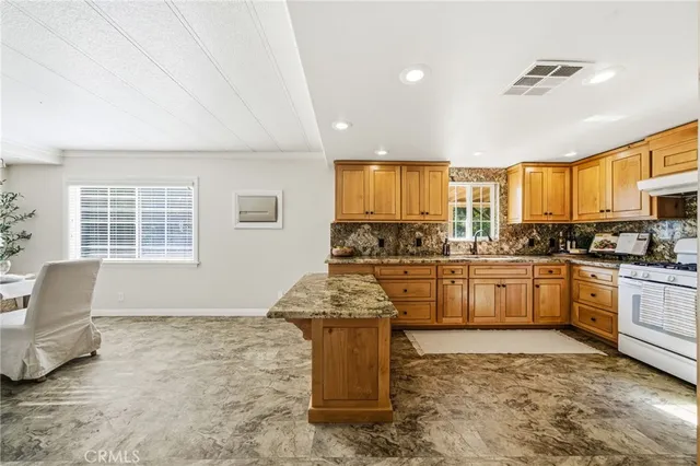 a bathroom with a granite countertop sink a mirror and a bathtub