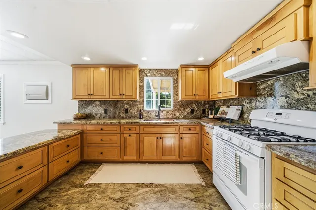 a living room with furniture a potted plant and a large window