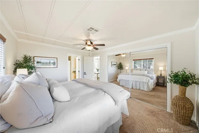 a view of a backyard with lawn chairs under an umbrella