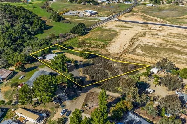 a view of a balcony with a street and trees