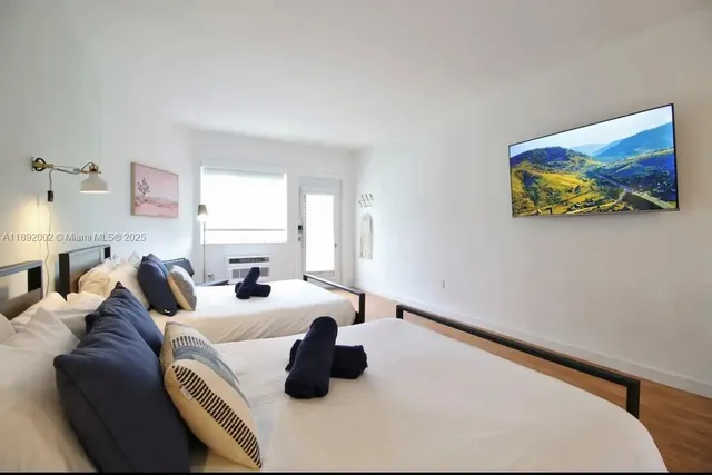 a bed room with a bed and a large window