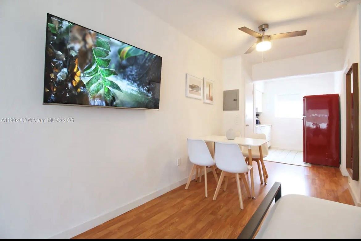 7721 Harding Avenue, Unit 9 Miami Beach, FL 33141 - Photo 6 of 10 a view of a dining room with furniture and wooden floor