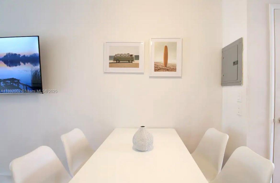 7721 Harding Avenue, Unit 9 Miami Beach, FL 33141 - Photo 7 of 10 a bathroom with a toilet sink and mirror