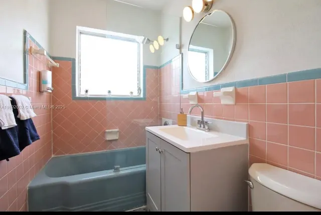 a bathroom with a sink toilet and a mirror