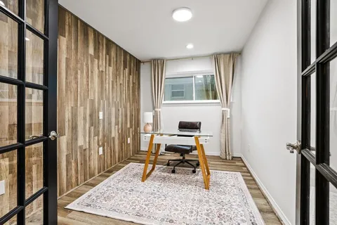 a view of a hallway with workspace and a window