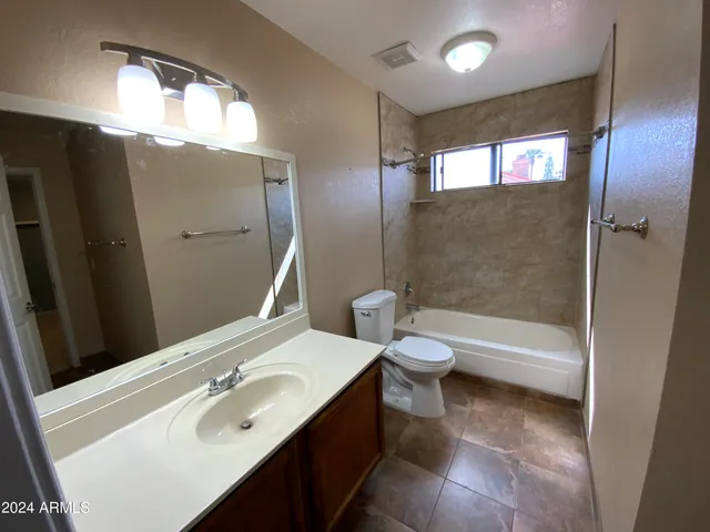 a bathroom with a sink a toilet and tub