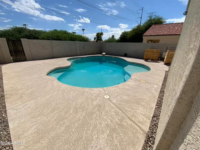 a view of a swimming pool with a yard