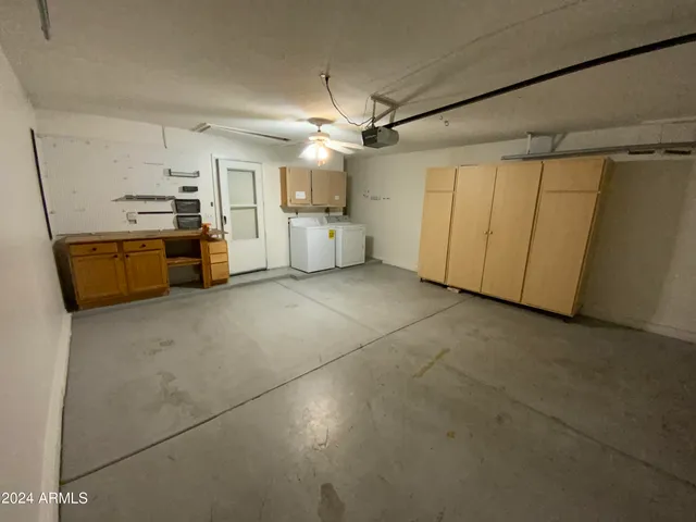 a view of a kitchen with a sink and a refrigerator