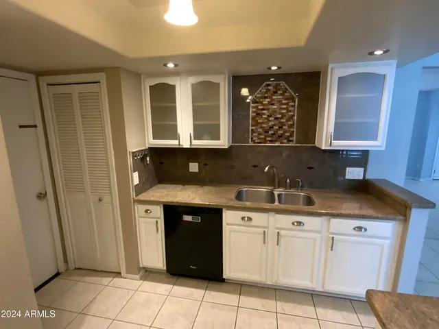 a kitchen with a sink and cabinets
