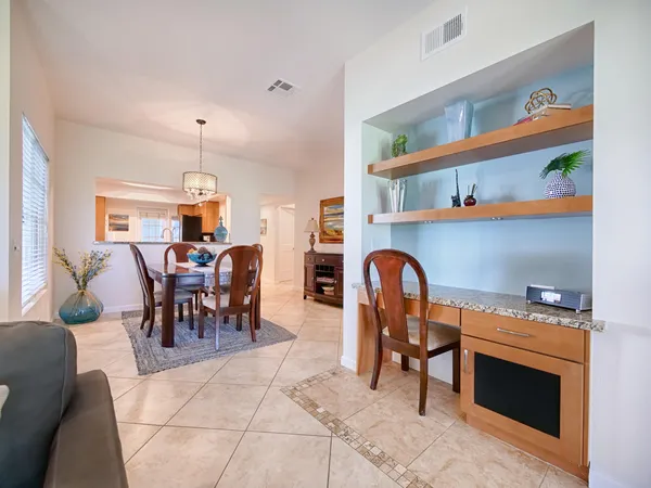 a living room with furniture a dining table and a fireplace