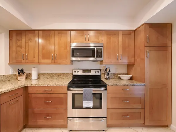 a kitchen with granite countertop cabinets stainless steel appliances and sink