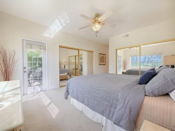 a bedroom with a large bed and a large window