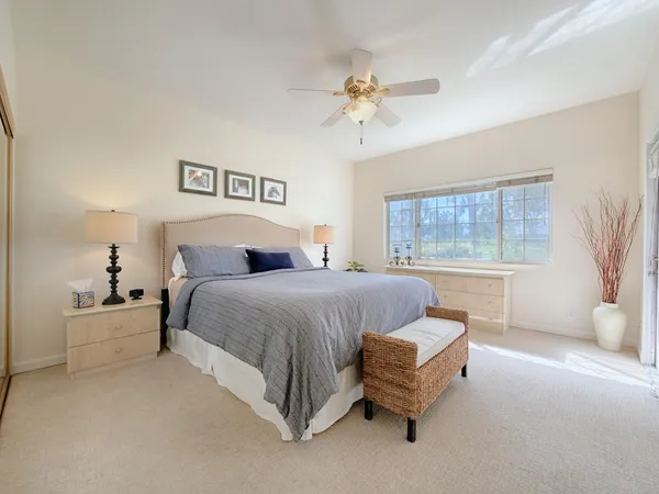 a spacious bedroom with a bed and window