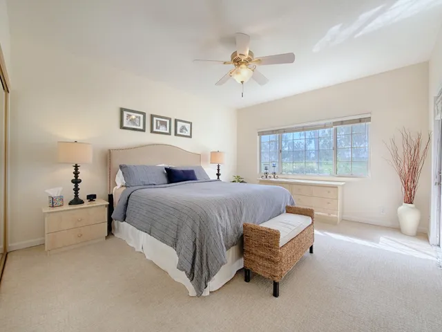 a spacious bedroom with a bed and window