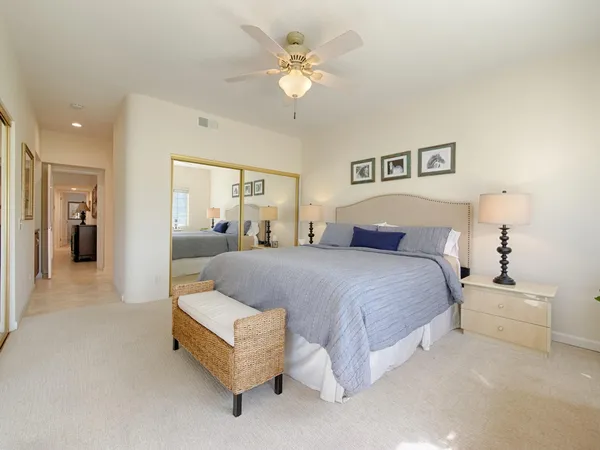 a spacious bedroom with a bed and a chandelier