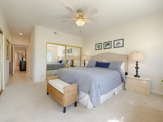a spacious bedroom with a bed and a chandelier