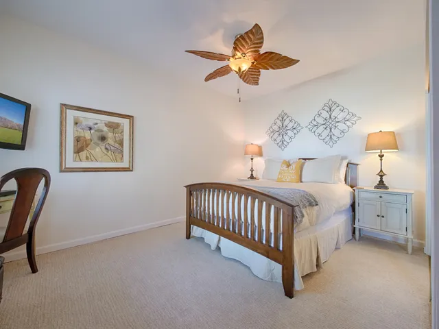a spacious bedroom with a bed and a chandelier