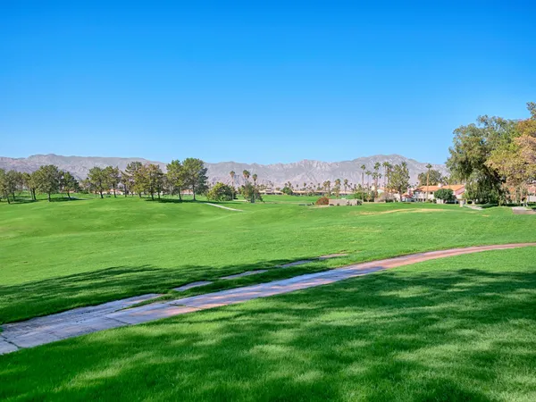 a view of a grassy field with clear sky