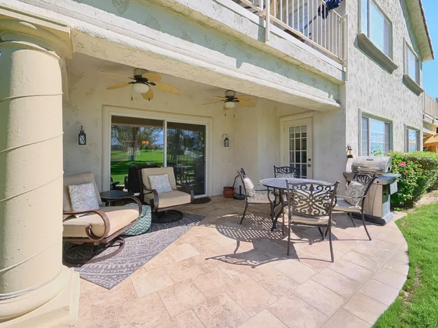 a building outdoor space with patio furniture and potted plants