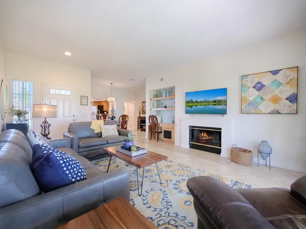 a living room with furniture fireplace and a window