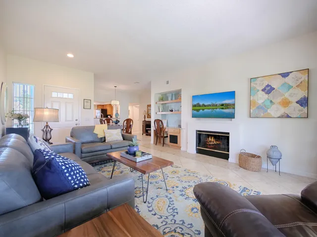 a living room with furniture fireplace and a window