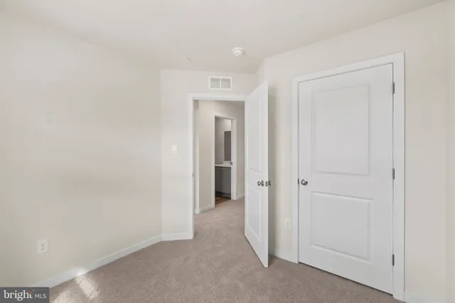 a view of a hallway to rooms