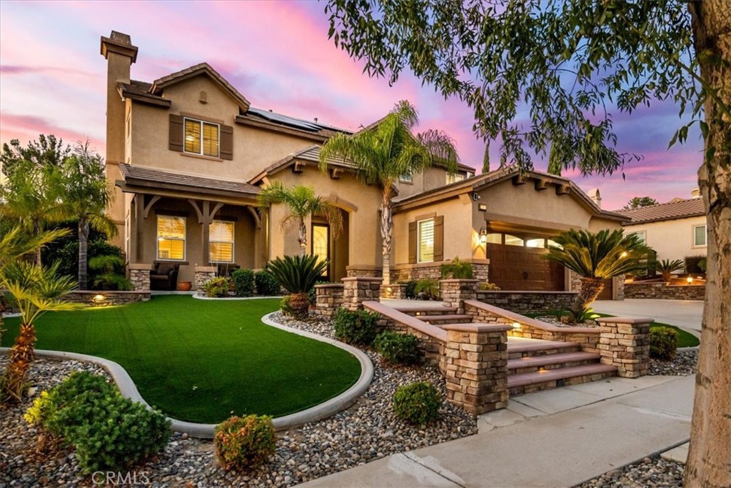 a front view of a house with garden