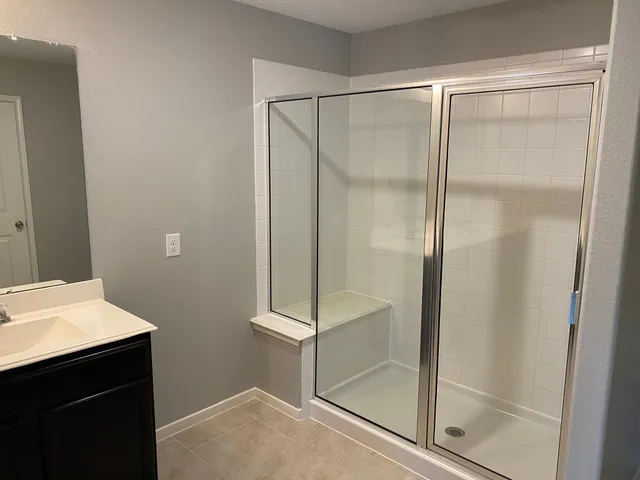 a bathroom with a glass shower door