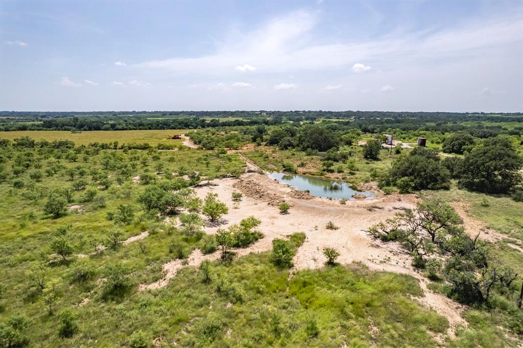 196 County Road 196 Bangs, TX 76823 - Photo 22 of 27 a view of a lake with a building in the background