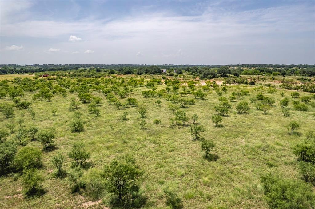196 County Road 196 Bangs, TX 76823 - Photo 24 of 27 a view of a big yard with an outdoor space and seating area