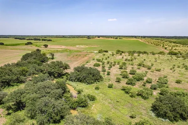 a view of a field with an ocean view