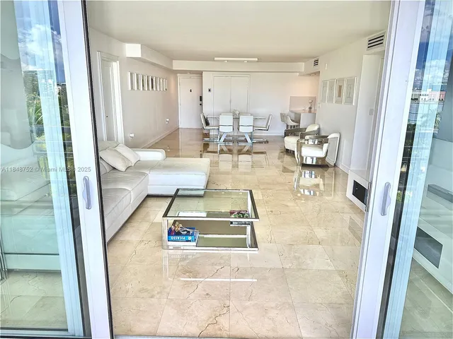 a bedroom with a bed a mirror and a table