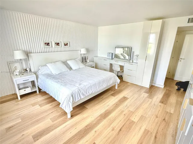 a bedroom with a flat screen television and a bed