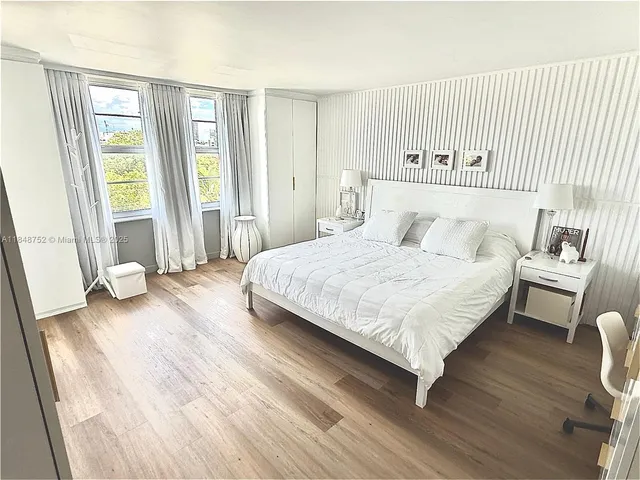 a bedroom with a bed and a night stand