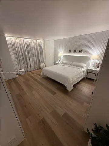 a view of a porch with wooden floor and door