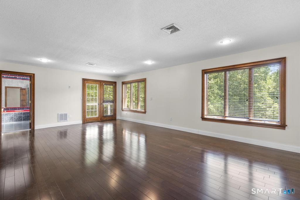 49 Partridge Lane Middletown, CT 06457 - Photo 18 of 39 a view of an empty room with wooden floor and a window