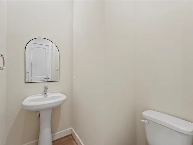 a bathroom with a sink a mirror and a toilet